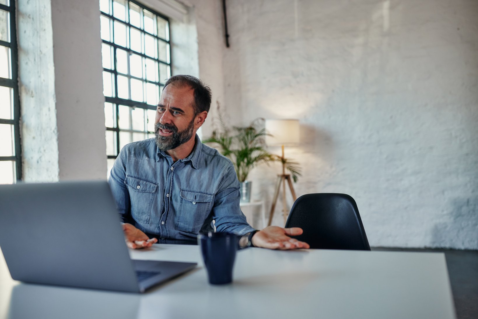 Man during online therapy session