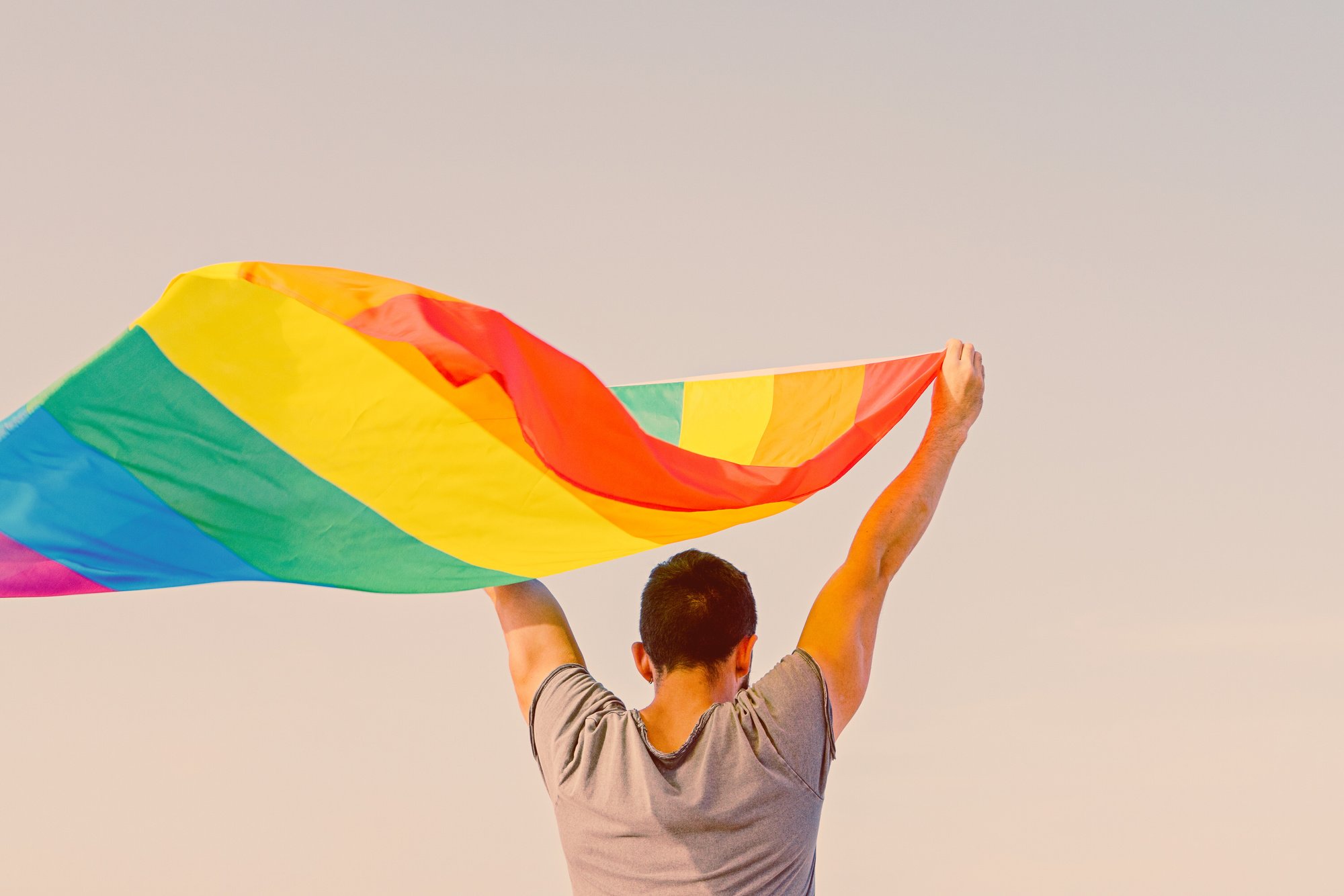 Man Holding LGBT Rainbow Flag